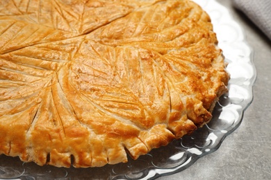 Traditional galette des rois on light grey table, closeup