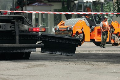 MYKOLAIV, UKRAINE - AUGUST 04, 2021: Road repair machinery on city street