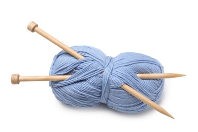 Soft light blue woolen yarn with knitting needles on white background