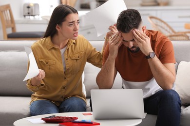 Young couple having argument about family budget at home