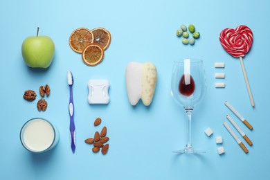 Photo of Flat lay composition with good and bad food for teeth on light blue background