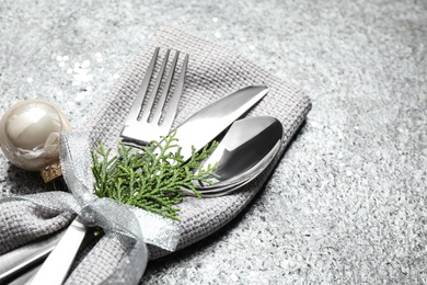 Cutlery set on grey textured table, closeup. Christmas celebration