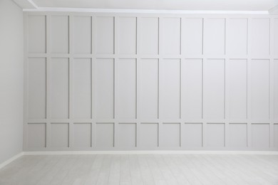 Empty spacious room with white wooden floor and walls