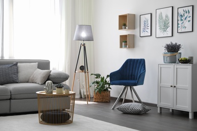 Elegant living room with comfortable furniture near window. Interior design
