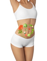 Image of Slim young woman and images of vegetables on her belly against white background. Healthy eating