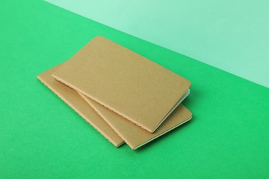 New stylish kraft planners on color background