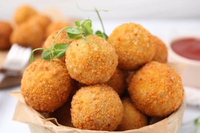 Photo of Delicious fried tofu balls with pea sprouts in bowl, closeup