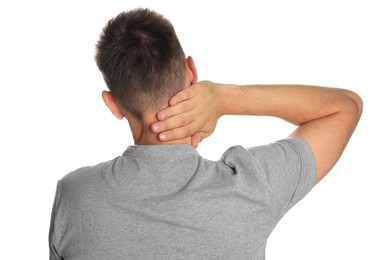 Man suffering from neck pain on white background, back view
