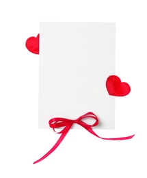 Blank card with red bow and red decorative on white background, top view. Valentine's Day celebration