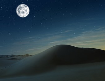 Image of Scenic view of sandy desert under starry sky with full moon in night 
