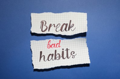 Torn paper with phrase Break Bad Habits on blue background, flat lay