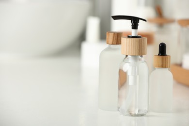 Photo of Different personal care products on countertop in bathroom, closeup. Space for text
