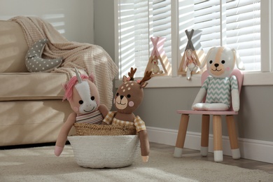 Photo of Funny toy unicorn, dog and deer in children's room.  Interior design