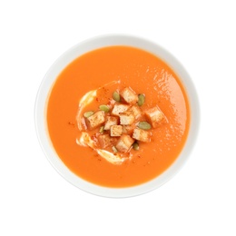 Tasty creamy pumpkin soup with croutons and seeds in bowl on white background, top view