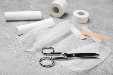 White bandage rolls and medical supplies on light grey table