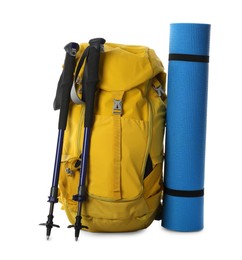 Trekking poles, backpack and camping mat on white background
