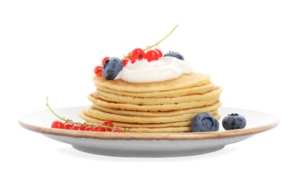 Tasty pancakes with natural yogurt, blueberries and red currants on white background