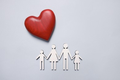 Figures of family and heart on light background, top view. Insurance concept