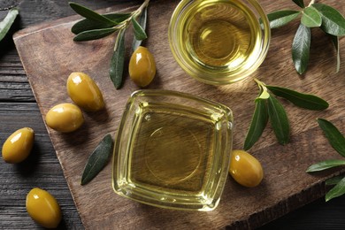 Flat lay composition with olive oil on black wooden table