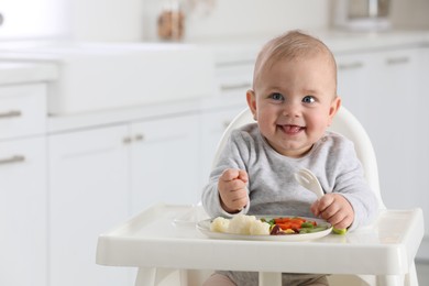 Photo of Cute little baby eating healthy food at home. Space for text
