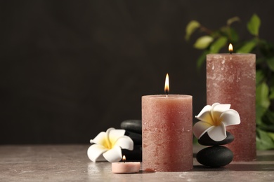Composition with candles and spa stones on marble table. Space for text