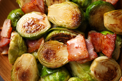 Delicious fried Brussels sprouts with bacon in bowl, closeup