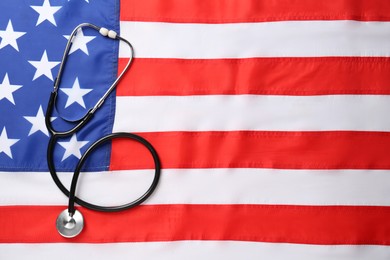Photo of Stethoscope on American flag, top view. Space for text