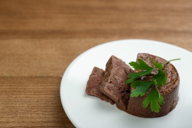 Plate with pate and parsley on wooden table. Pet food