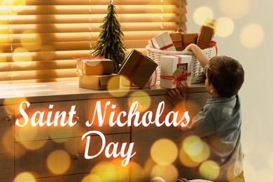 Saint Nicholas Day. Little boy with gifts at home