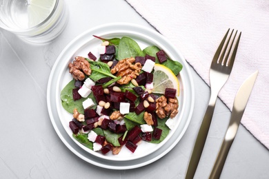 Delicious beet salad served on grey table, flat lay