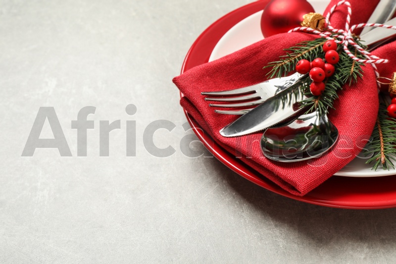 Beautiful Christmas table setting on light grey background. Space for text