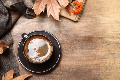 Flat lay composition with hot drink on wooden background, space for text. Cozy autumn