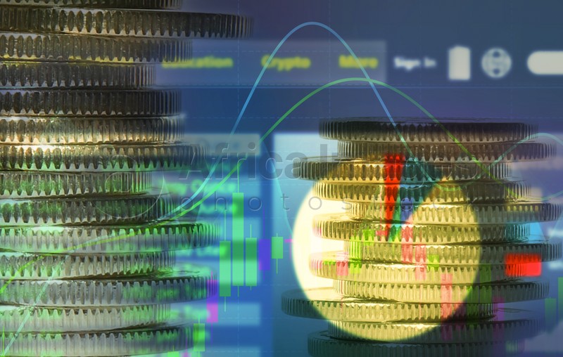 Image of Double exposure of electronic trading platform and stacked coins. Stock exchange