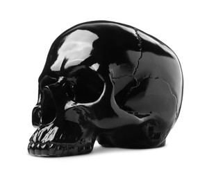 Photo of Black glossy skull with teeth isolated on white