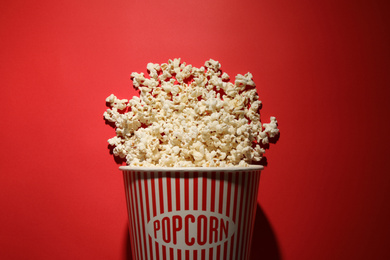 Delicious popcorn on red background, top view