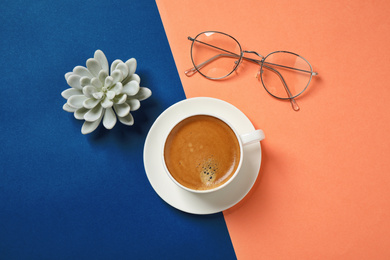 Flat lay composition with classic black coffee on blue and orange background. Color of the year 2020
