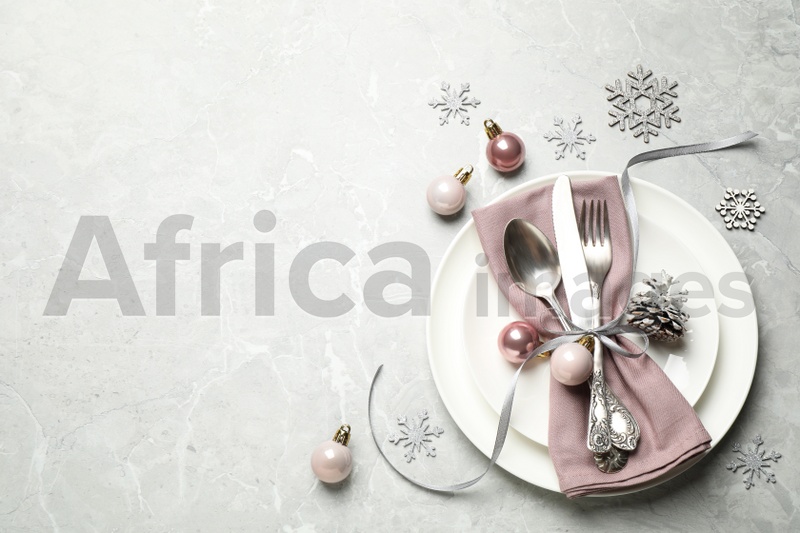 Beautiful Christmas table setting and festive decor on light grey marble background, flat lay. Space for text