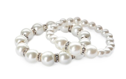 Elegant pearl bracelets on white background. Luxury jewelry