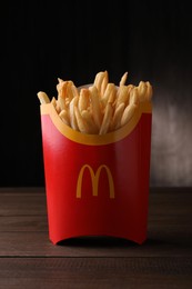 MYKOLAIV, UKRAINE - AUGUST 12, 2021: Big portion of McDonald's French fries on wooden table