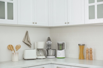 Modern toaster and other home appliances on countertop in kitchen