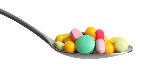 Spoon with different colorful pills on white background