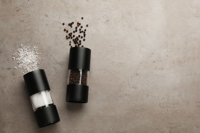 Photo of Salt and pepper shakers on light table, flat lay. Space for text