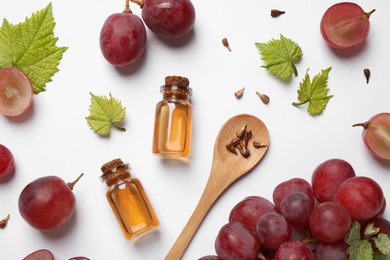 Composition with bottles of natural grape seed oil on white background, top view. Organic cosmetic