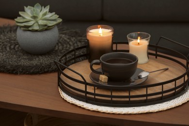 Freshly brewed coffee and decorative elements on wooden table in room