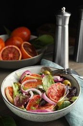 Bowl of delicious sicilian orange salad on wooden table. Space for text