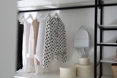 Storage rack with stylish women's clothes and accessories indoors