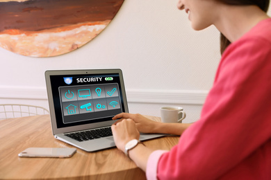Image of Woman using home security app indoors, closeup