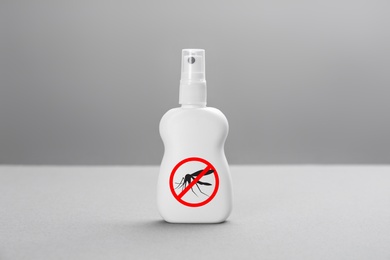 Bottle of insect repellent on grey background