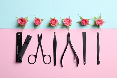 Manicure tools and roses on color background, flat lay