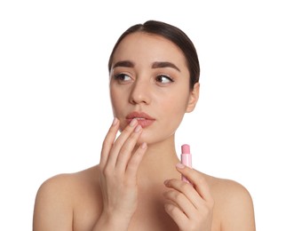 Young woman with lip balm on white background